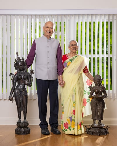 Haren and Pratima standing next to two sculptures